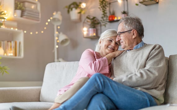 Happy_Senior_Couple_Sofa_At_Home