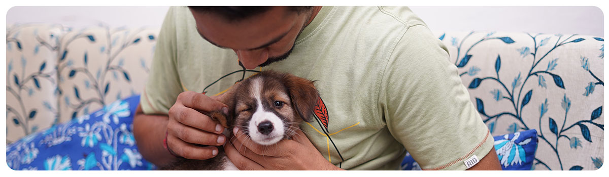 man holding a puppy