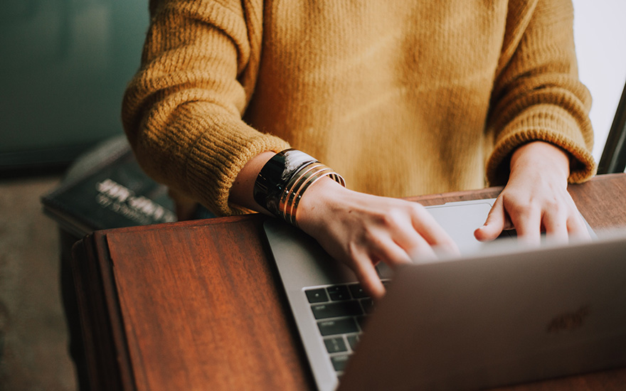 Woman typing on laptop keyboard