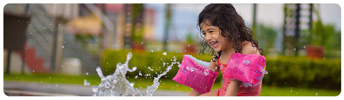 child with armbands in swimming pool