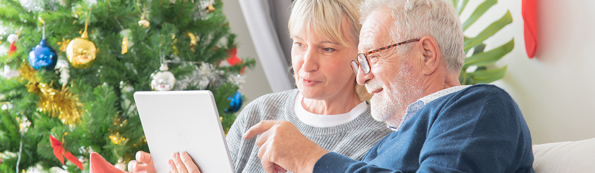 Couple looking at property on a tablet over Christmas