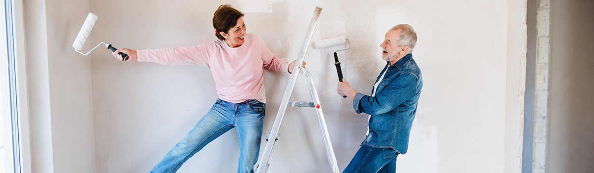 Couple on a ladder decorating