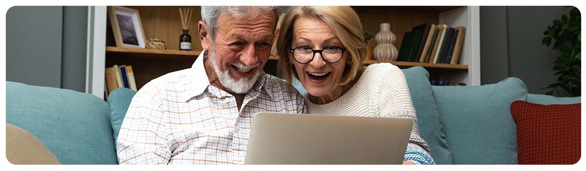 Older couple on a laptop looking at houses