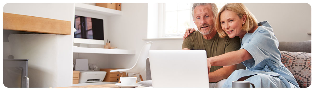 Couple looking for property on their laptop