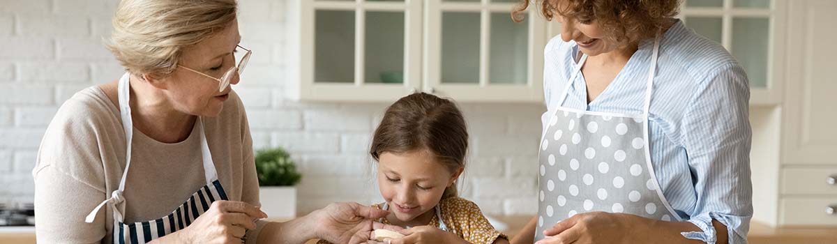 Grandmother, daughter and granddaughter baking biscuits