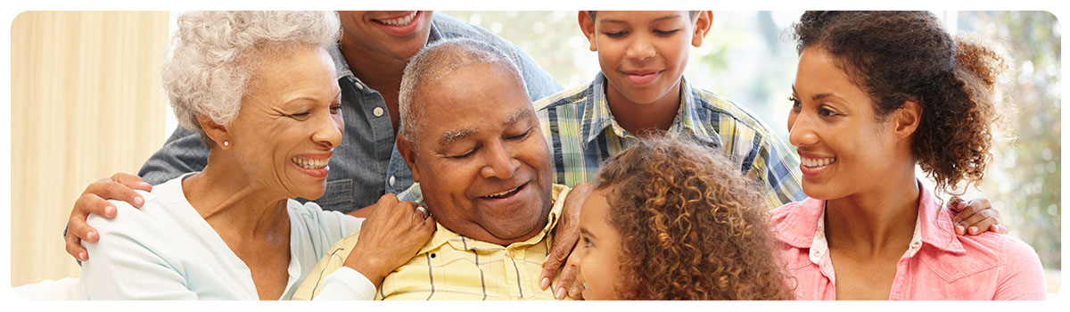 Multi-generational family sitting together on a sofa