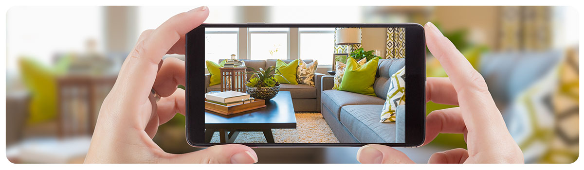 someone taking a photo of a house interior with a mobile phone