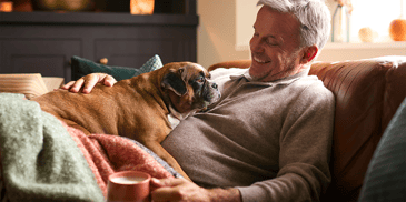 man on sofa with dog